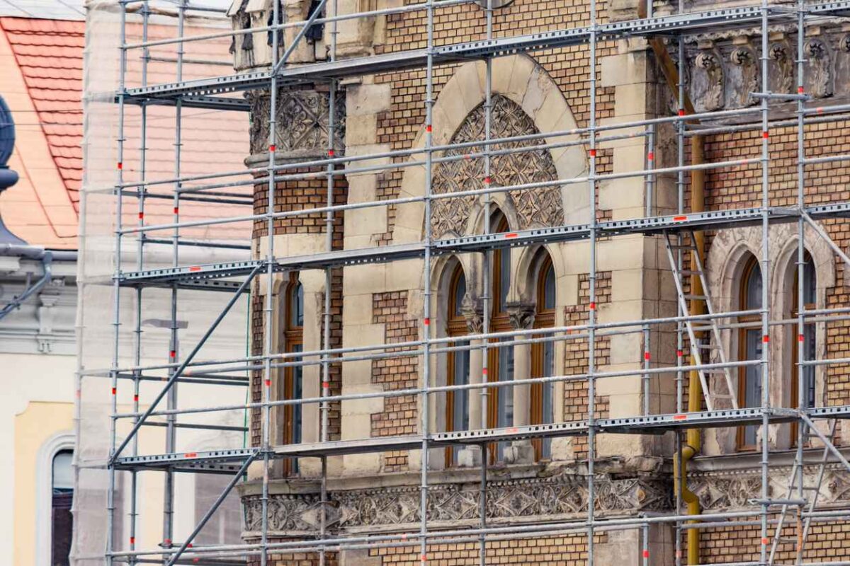 Restoration of an old European historic building with scaffolding next to it